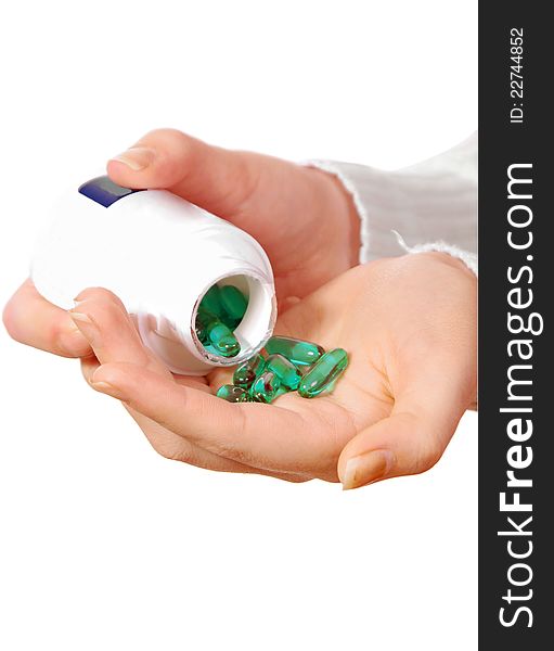 Female hand with medicine pills on white. Female hand with medicine pills on white