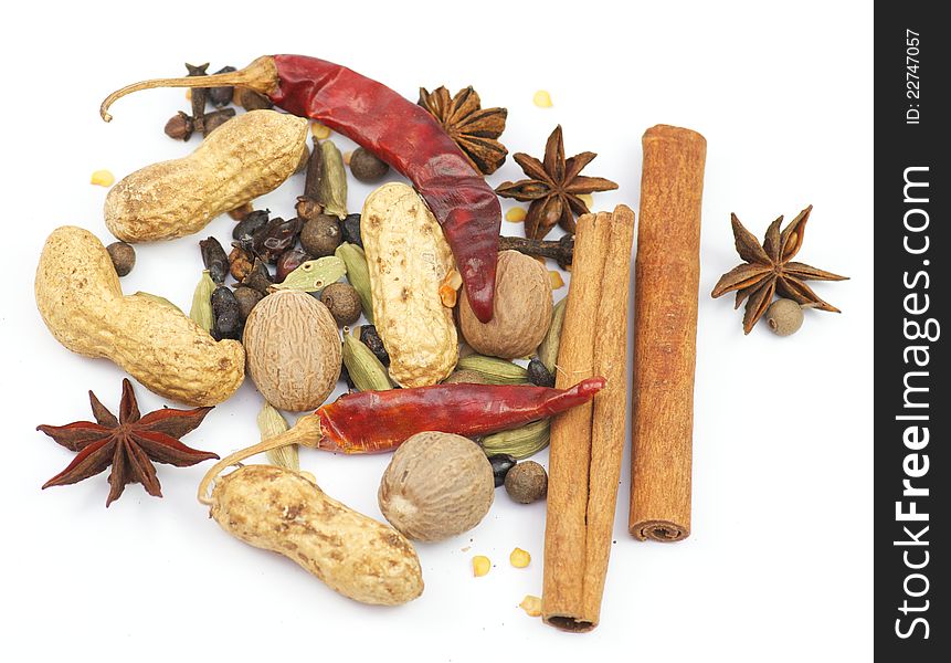 Anise and spicy, cinnamon and peppers, nuts and clove on white. Anise and spicy, cinnamon and peppers, nuts and clove on white