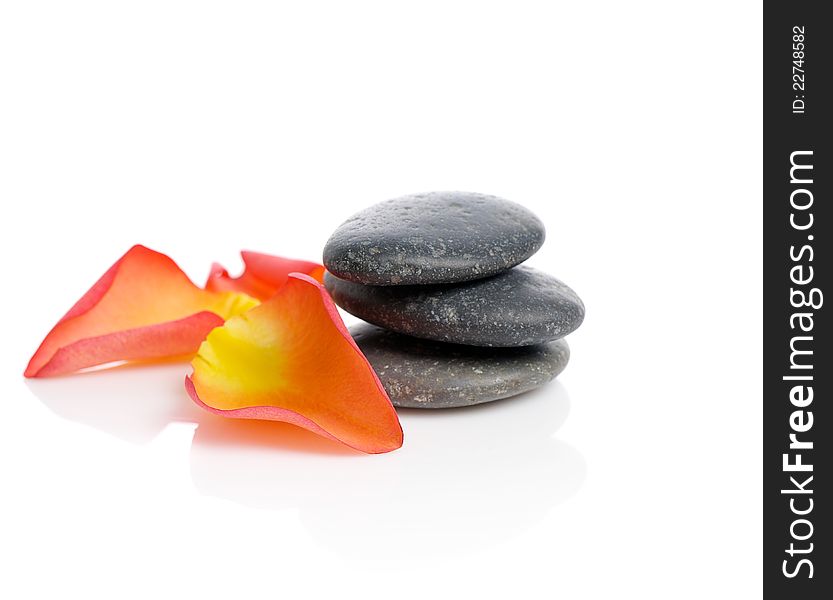 Spa stones with rose petals  on white background