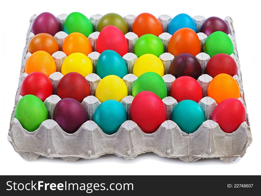 Colorful easter eggs in carton  on white background