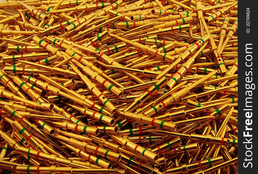 Golden plated electrical contacts of pin type with green and red rings. Golden plated electrical contacts of pin type with green and red rings