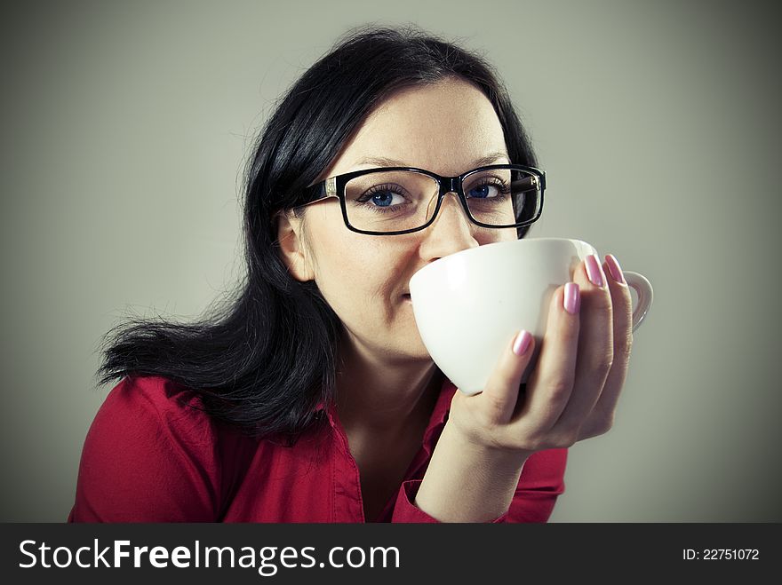 Brunette girl with glasses trying to flavored coffee. Brunette girl with glasses trying to flavored coffee