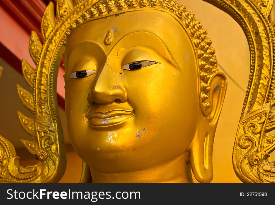 Buddha face close-up golden. Buddha face close-up golden