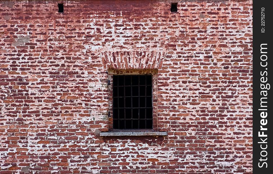 Window with bars in the old brick wall. Window with bars in the old brick wall