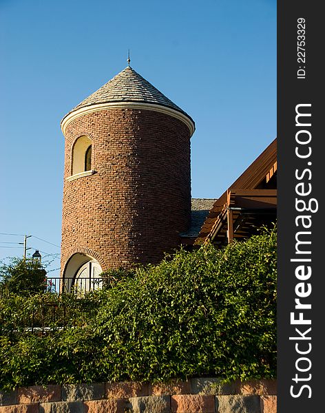 Tower portion of vineyard building. Brick tower with greenery. Tower portion of vineyard building. Brick tower with greenery.