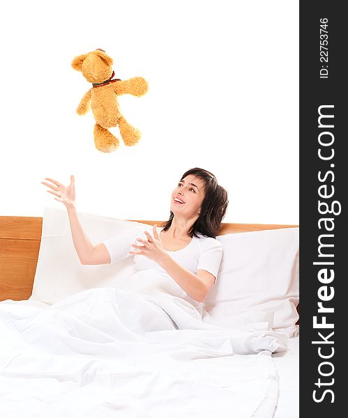 Woman In Bed Throwing Teddy Bear