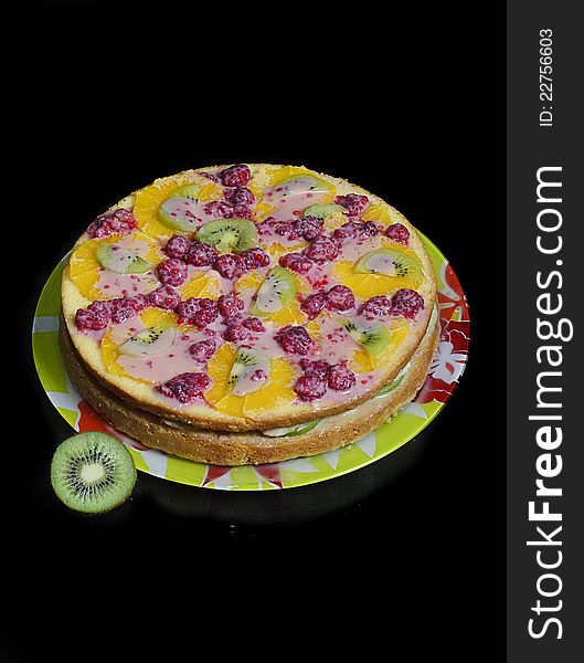 Pie stuffed with sliced ​​berries decorated orange, kiwi and raspberries. Pie stuffed with sliced ​​berries decorated orange, kiwi and raspberries