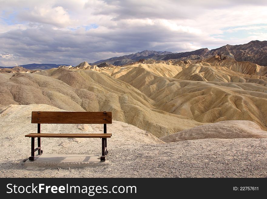 A bench waiting for someone to sit on it at Death Valley National Park in California . A bench waiting for someone to sit on it at Death Valley National Park in California .