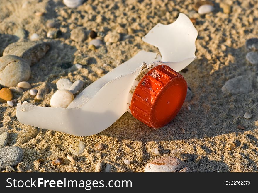 Fragment of plastic container with a red cap