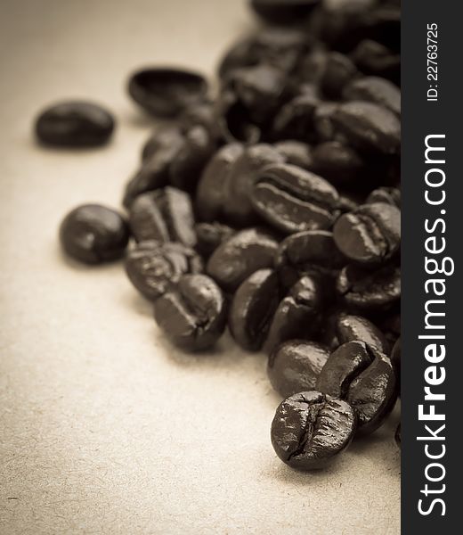 Coffee beans on cardboard, in sepia