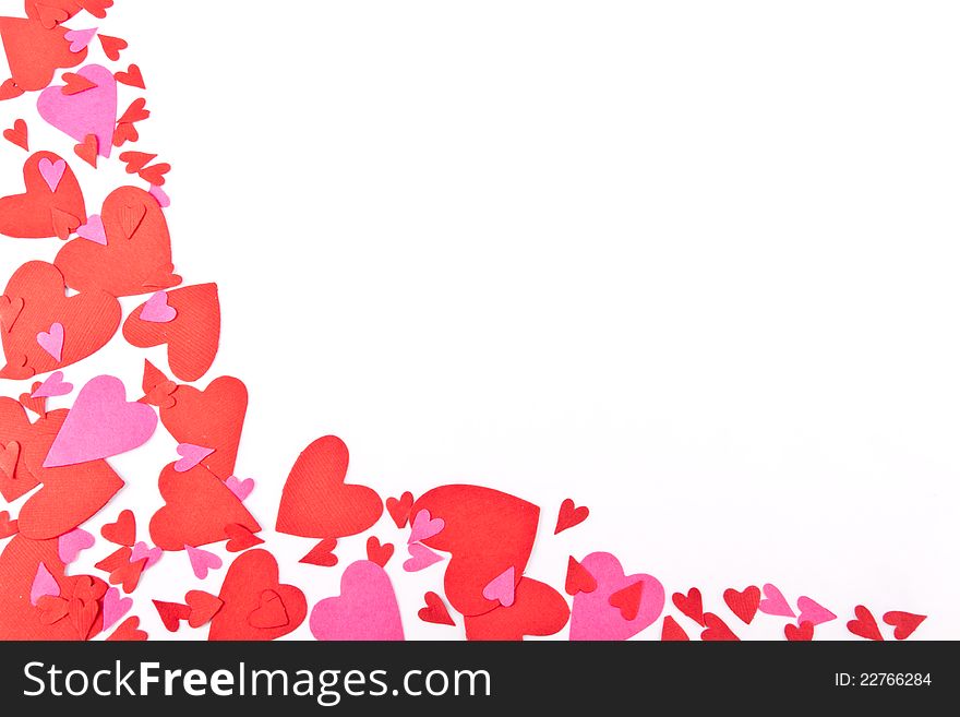 Red and Pink Confetti shaped like hearts set on a white background with copy space. Red and Pink Confetti shaped like hearts set on a white background with copy space