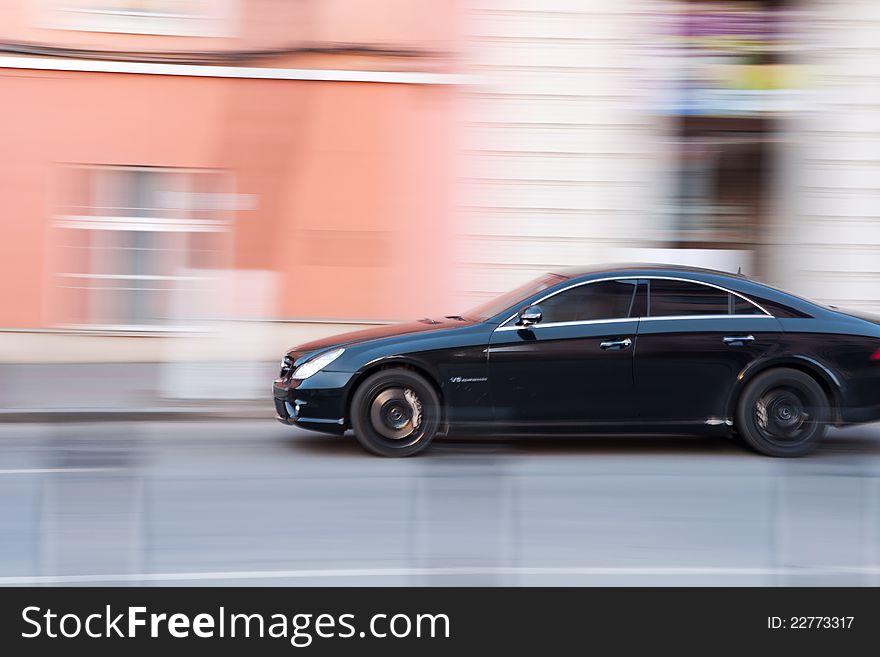 Panning image of a moving car. Panning image of a moving car