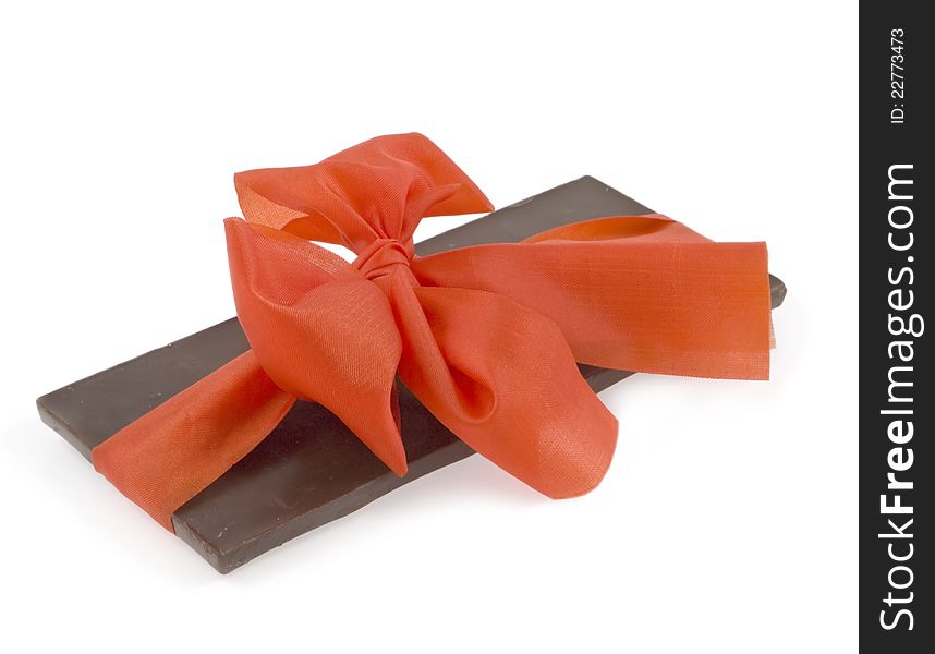 Red bow on the stick of black chocolate. Red bow on the stick of black chocolate