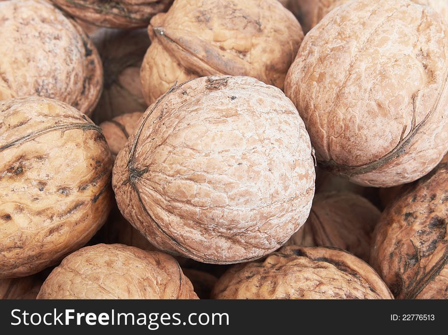 Close up of scattered walnuts. Background.