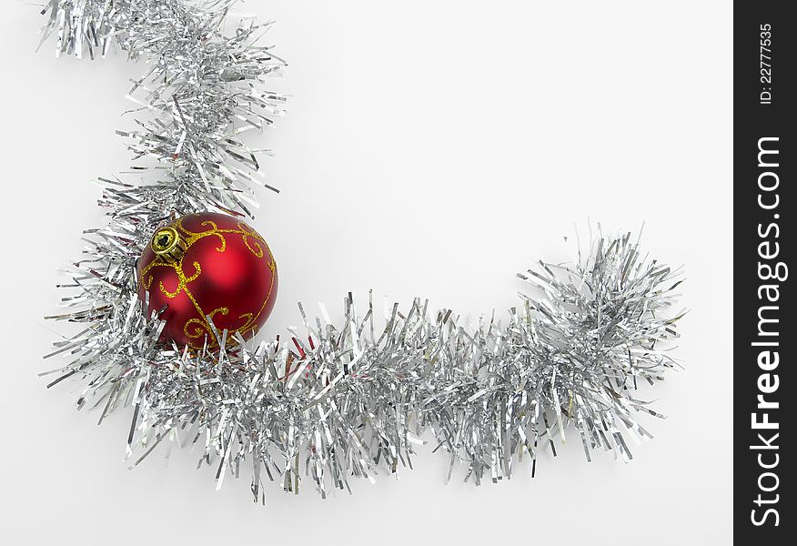 Christmas toy surrounded by tinsel on a white background