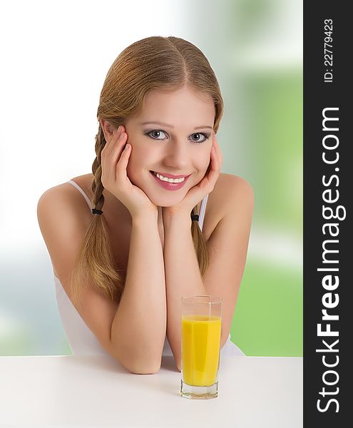 Portrait of beautiful happy cheerful girl with orange juice