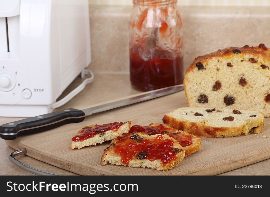 Raisin bread with toasted slices with jam on a cutting board