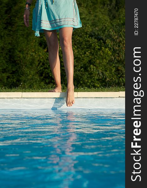 Woman barefoot at swimming pool border in Asturias Spain. Woman barefoot at swimming pool border in Asturias Spain