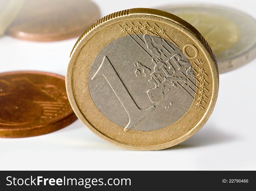 One euro coin of other coins in background