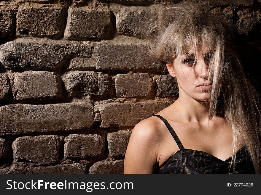 Portrait of girl at a brick wall