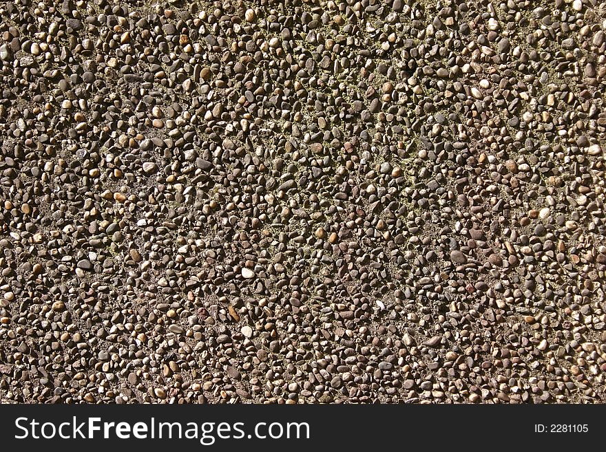 Wall made of concrete and little pebbles as background. Wall made of concrete and little pebbles as background