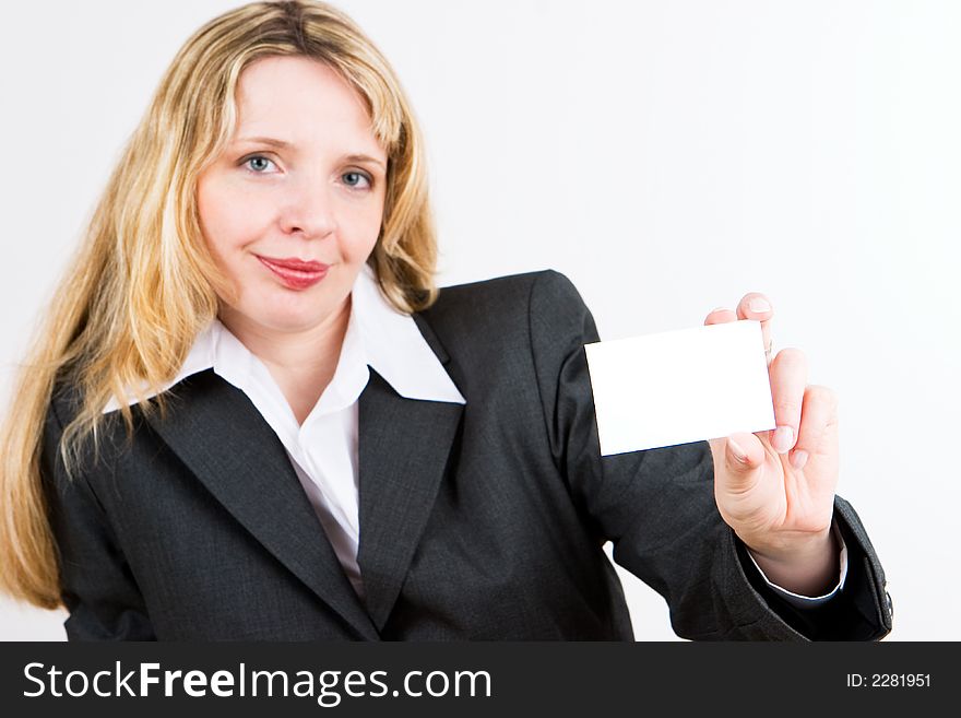 A blond business woman in a suit holding a blank business card. A blond business woman in a suit holding a blank business card