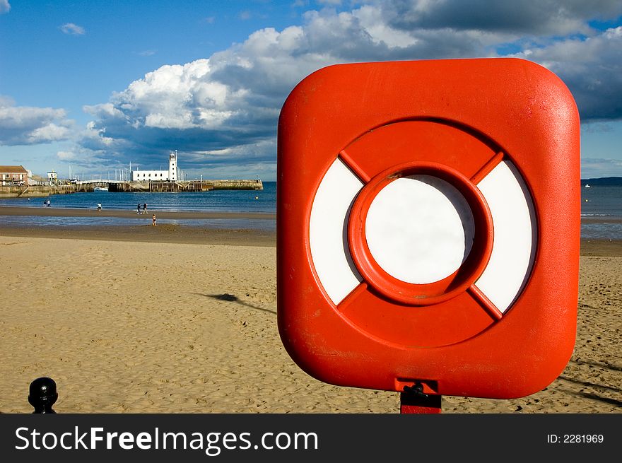 Lifebuoy ring with a lighthouse in the background