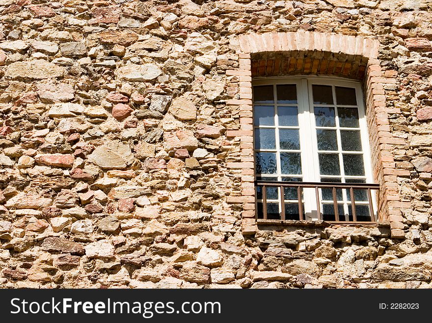 An old stone wall with a window