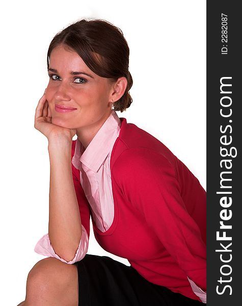 Young lady with hand on knee and chin, red sweater, pink top looking at the camera. White isolated back ground. Young lady with hand on knee and chin, red sweater, pink top looking at the camera. White isolated back ground.