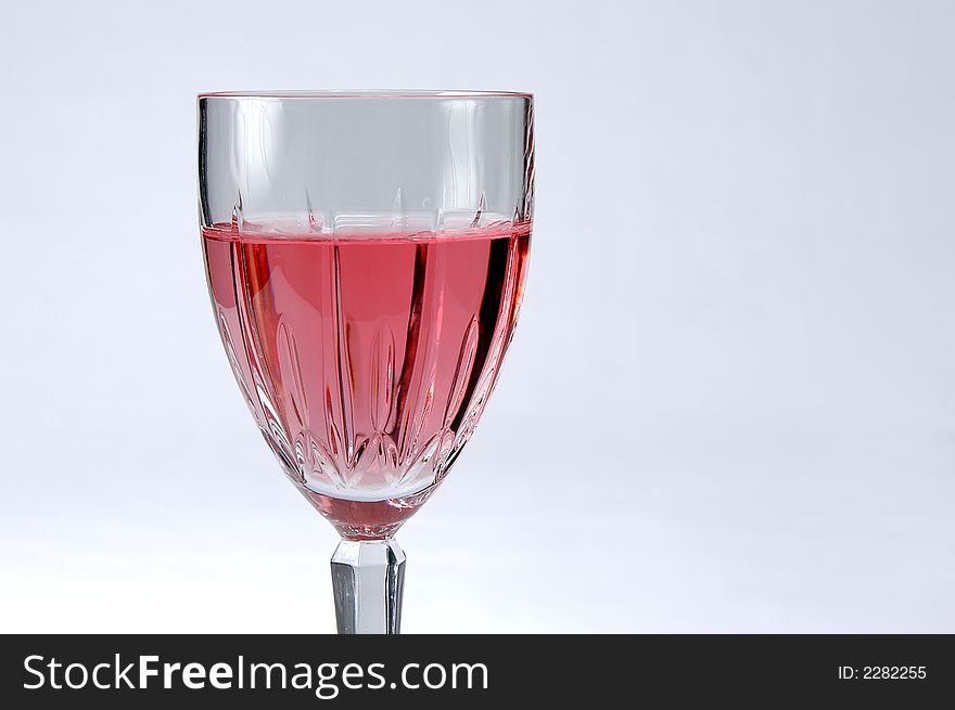 Glass of zinfandel wine over a neutral background