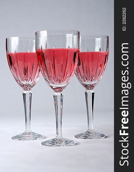 Three Glasses with Zinfandel wine over a neutral background. Three Glasses with Zinfandel wine over a neutral background