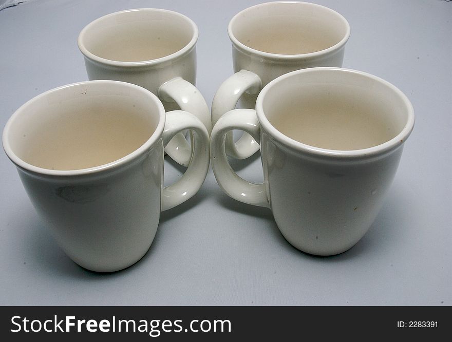 Four white drinking glass on a white bakcground. Four white drinking glass on a white bakcground