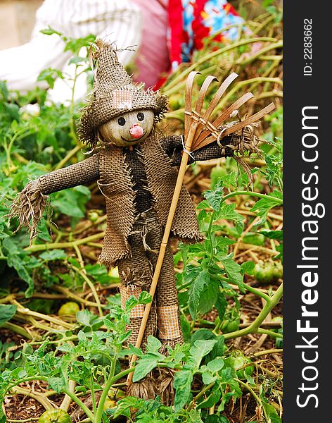 Scarecrow built by children for the garden in their school. Scarecrow built by children for the garden in their school