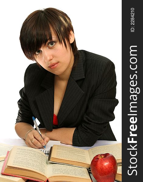 The young girl with books and a red apple, isolated on white