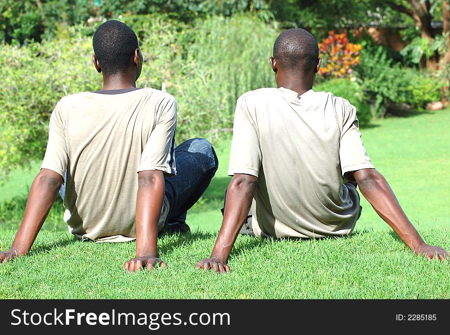 Two young african men relaxing in the garden. Two young african men relaxing in the garden