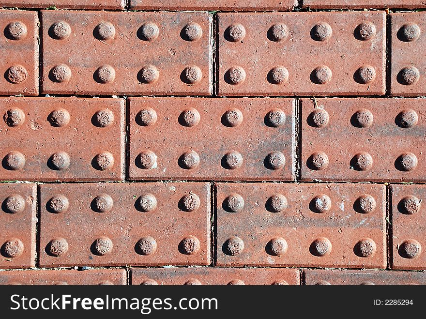 Textured red bricks laid out in a row pattern