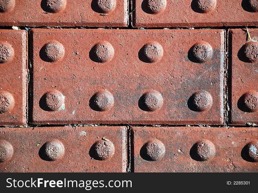 Textured red bricks lined up in a row pattern