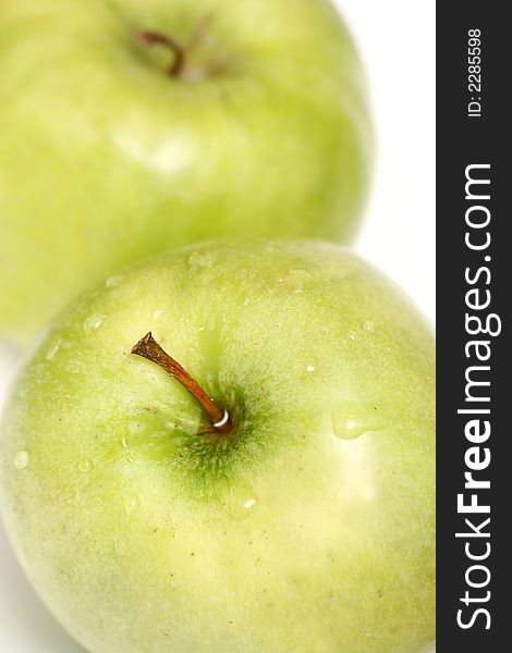 Two green apples on a white background