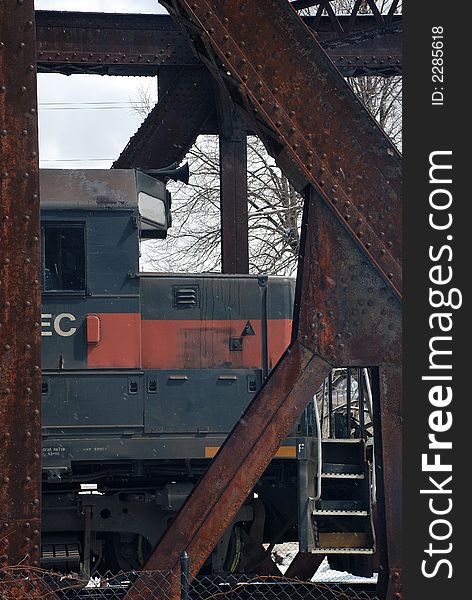 Front of locomotive framed in trastle, taken in Berskshire, MA, on overcast, snowy day. Front of locomotive framed in trastle, taken in Berskshire, MA, on overcast, snowy day.