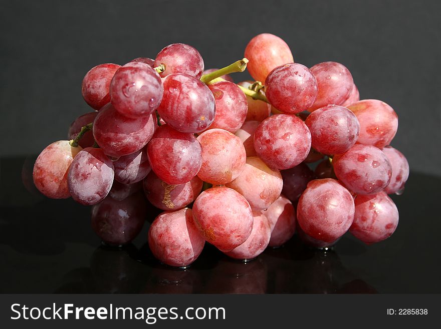Cluster of red grape on the table