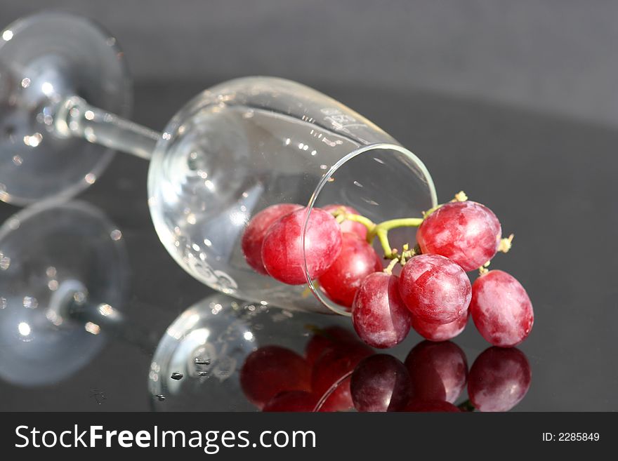 Red grape in the wine glass. Red grape in the wine glass