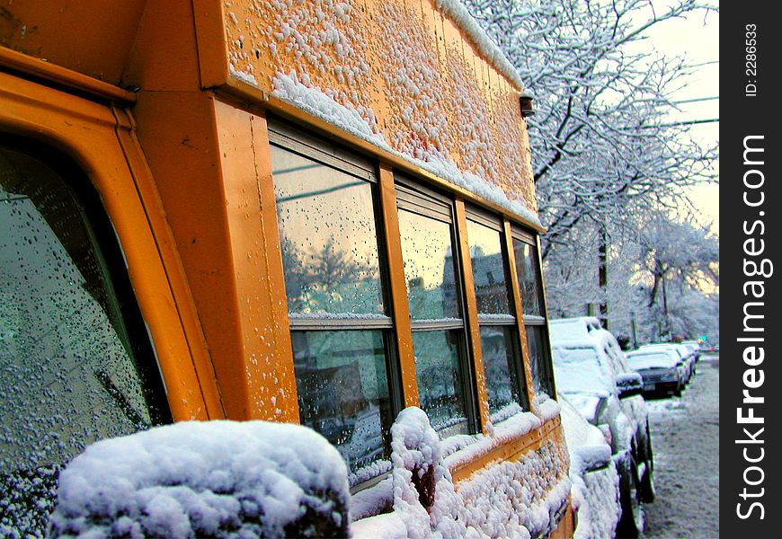 The short School bus on a snowy winter day. The short School bus on a snowy winter day