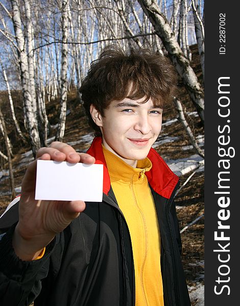 Young the man with the card in a hand on a background of the nature. Young the man with the card in a hand on a background of the nature.