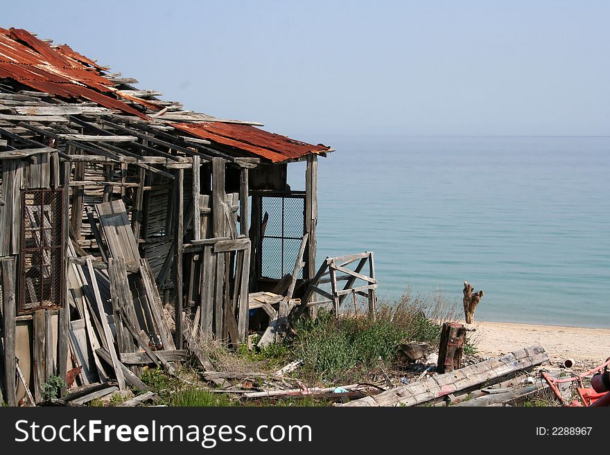 Delapidated boathouse on sea front with copy space