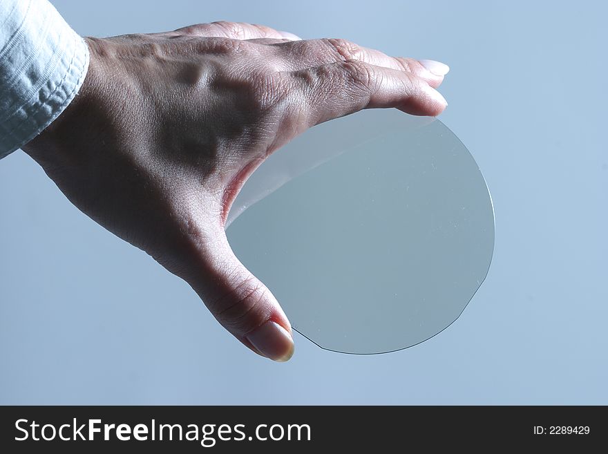 Translucent microchip plate in womans hand