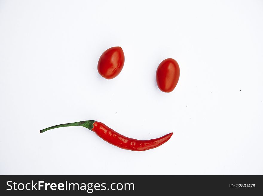 Smile made of tomatoes and peppers. Smile made of tomatoes and peppers
