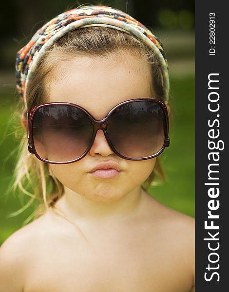 The little girl wears a large adult sunglasses, Asian-mestizo