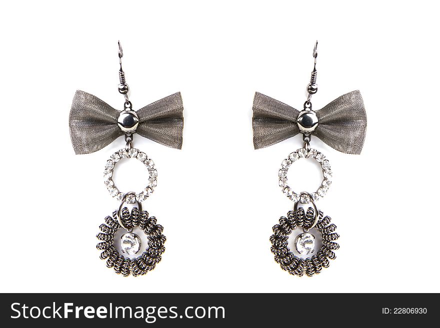 Earrings with rings and bow on white background