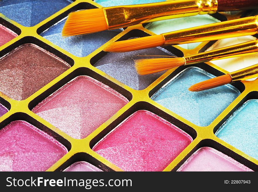 Decorative colorful eyeshadow and brushes , close up shot. Decorative colorful eyeshadow and brushes , close up shot