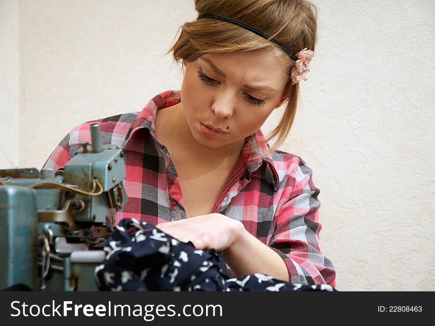 Woman Seamstress Posing Near Sewing Machine